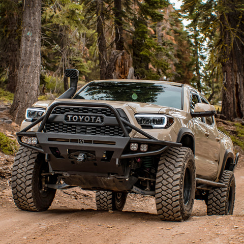 Tan Tacoma on a mountain trail with a C4 Hybrid bumper with full-height bull bar with tube gussets.
