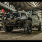 Low angle view of the C4 Overland bumper with full-height bull bar with tube gussets installed on a grey 2nd Gen Tundra.