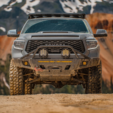Front view of a grey Tundra in the mountains with a US-made steel front winch bumper from C4 Fabrications based in Sturgis, South Dakota. 
