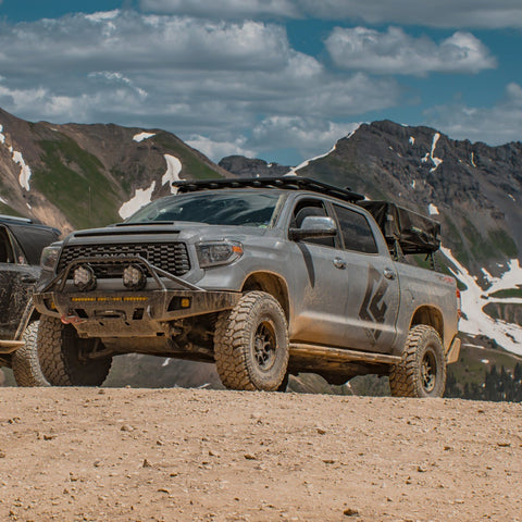 Grey Tundra CrewMax exploring the mountains with C4 Overland bumper installed.