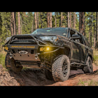 Black Toyota 4Runner spanning a dirt crevasse and equipped with the Hybrid tube/plate bumper manufactured by C4 Fabrication in Sturgis, SD.