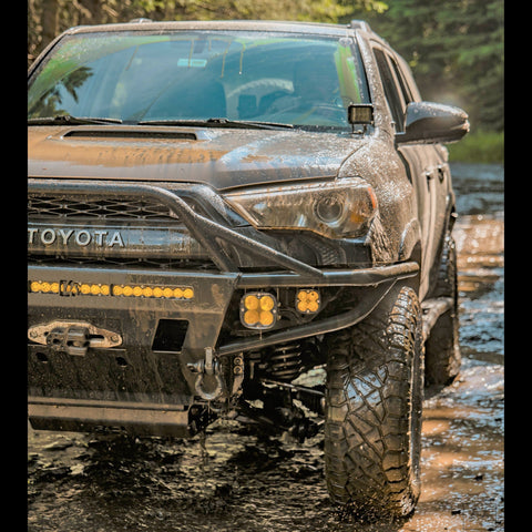 4th Gen 4Runner dripping water and mud after offroading in the mountains.