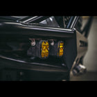 Close up of two Baja Designs lights mounted in the wings of a C4 Hybrid bumper.