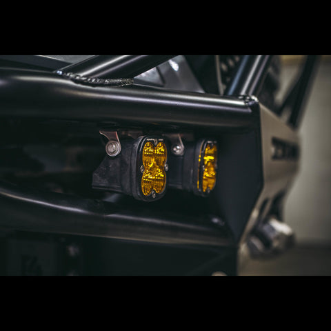 Close up of two Baja Designs lights mounted in the wings of a C4 Hybrid bumper.
