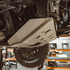 Close-up view showing the front oil filter access panel removed from the C4 front skid plate for Toyota 4Runners.
