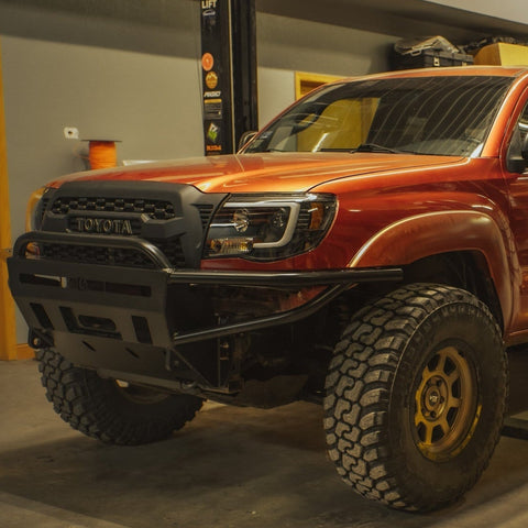 Red Tacoma with a freshly-installed C4 Hybrid front bumper.
